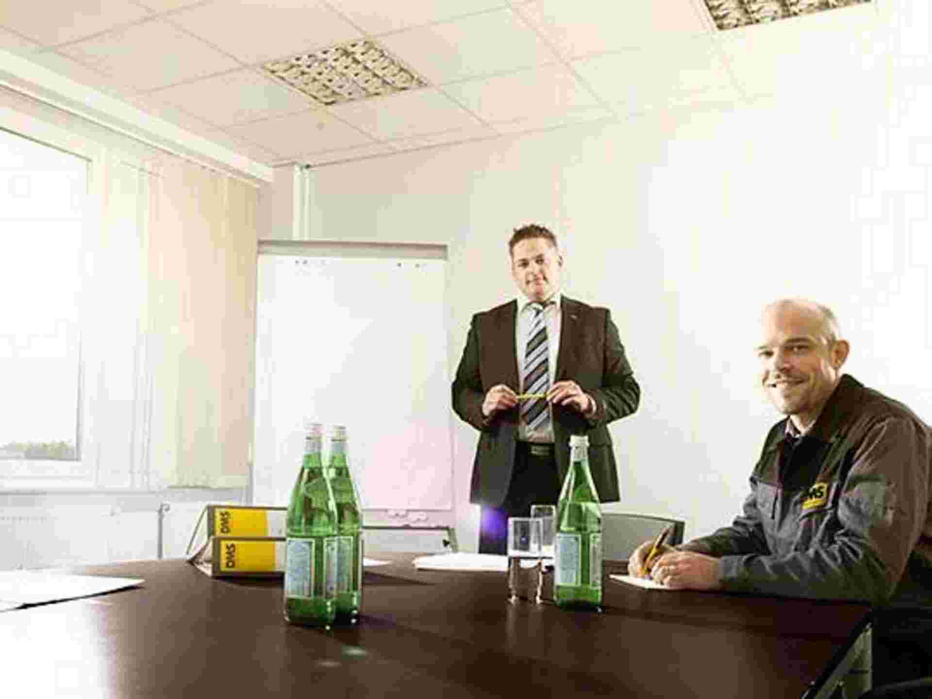 Drei Umzugsspezialisten aus verschiedenen Abteilungen der Max Müller Umzüge GmbH planen einen Projektumzug