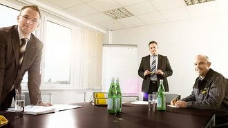 Three relocation specialists from different departments of Max Müller Umzüge GmbH are planning a project relocation